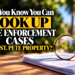 Magnifying glass over property documents, representing how to look up St. Pete code enforcement cases