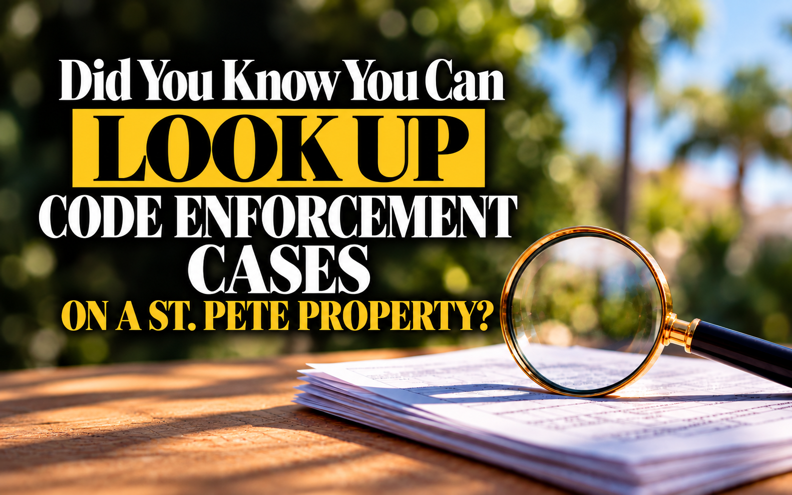 Magnifying glass over property documents, representing how to look up St. Pete code enforcement cases