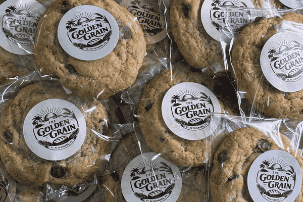 Individually wrapped chocolate chip cookies with The Golden Grain logo stickers